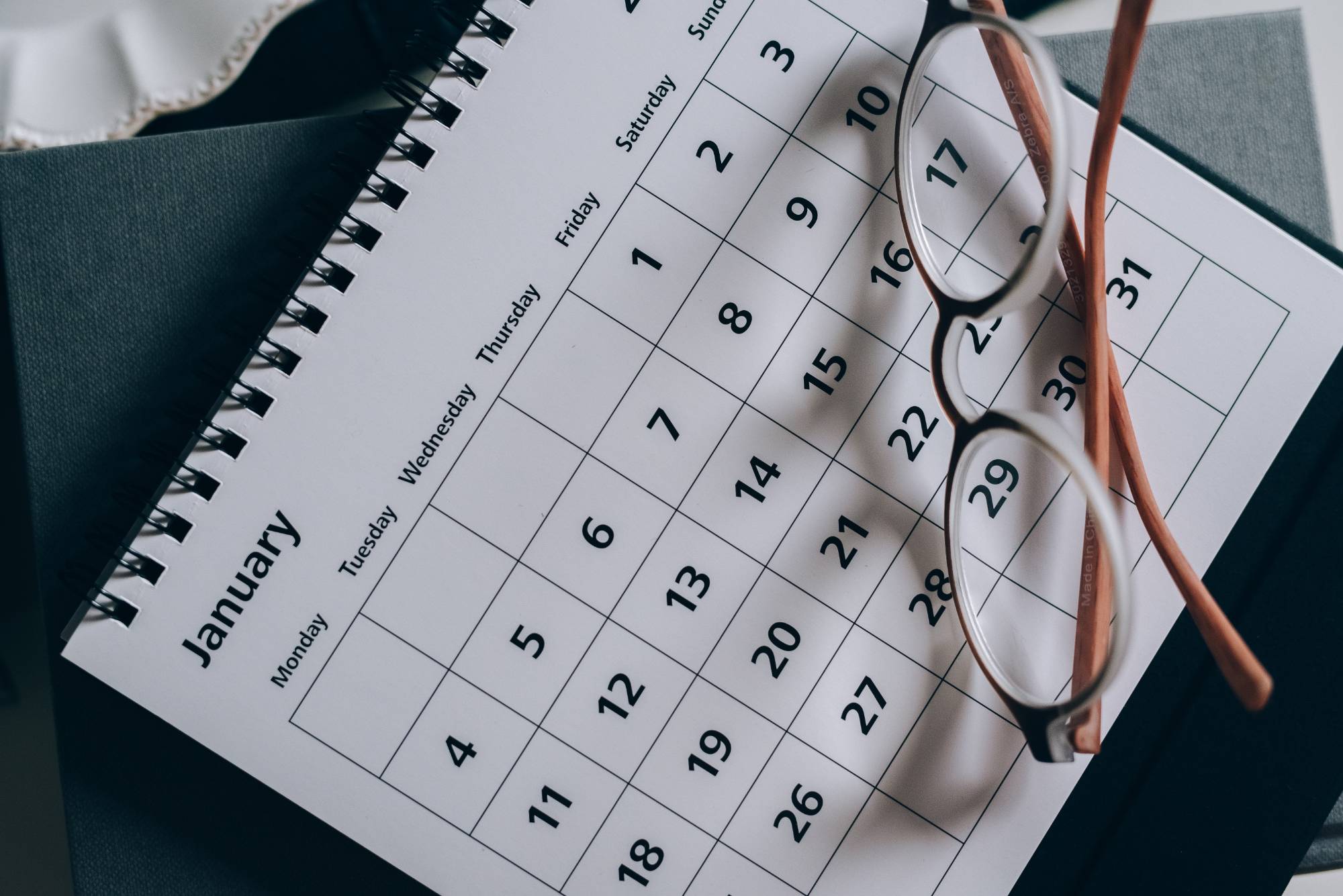 Photo of a calendar with glasses on top